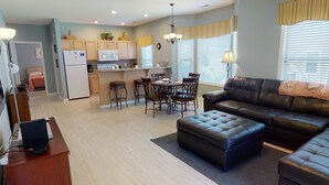 A modern apartment with a kitchen, dining area, and living room.