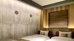 A hotel room with two beds, a concrete accent wall, wooden paneling, and a window with blinds. - Asakusa Kaminarimon Takenoyado (Tokyo)