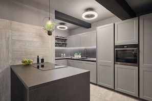 Enjoy cooking in this well-equipped kitchen with a central island, sink, and stainless steel oven.
