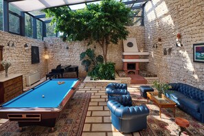 Relax by the fireplace, play a game of pool, or unwind on the leather sofas in this cozy indoor space.