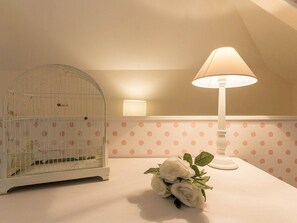 Cozy retreat with a birdcage, elegant table centerpiece, and soft lighting.