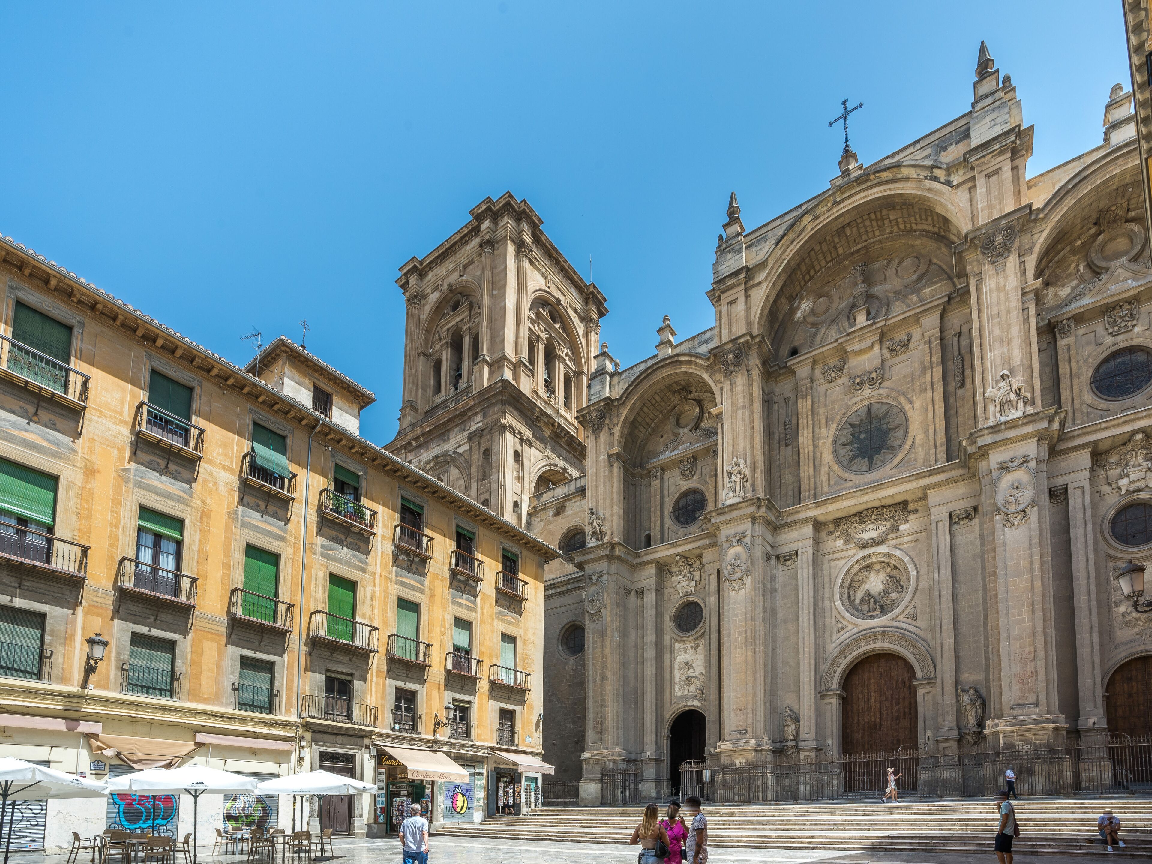 A historic building with ornate architecture, including a bell tower and large arched windows.