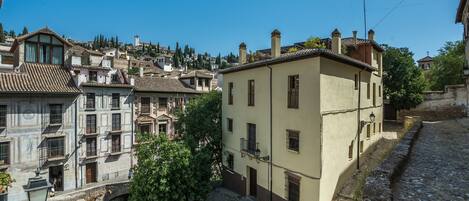 A historic town with traditional architecture, cobblestone streets, and a prominent building with a balcony.