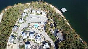 An aerial view of a coastal residential area with houses, a swimming pool, and a dock. - Bluff Cabin #4 Lake Retreat, Lake Views & a Relaxing Hot Tub, NO pet cabin (Kimberling City)
