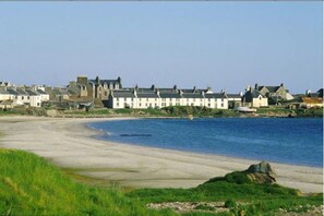 A coastal town with white buildings along the shoreline.