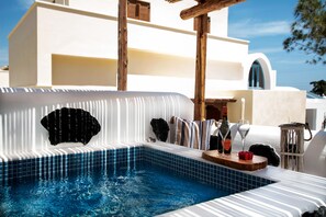 A swimming pool with a tiled edge and a wooden deck area.
