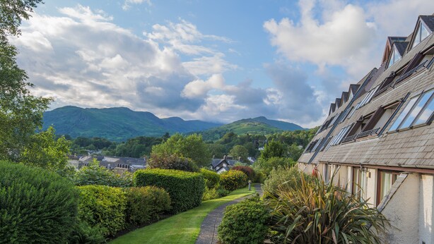 A residential area with a pathway leading to a house with multiple windows and a sloped roof. - Serendipity- Romantic 1-bed Apt Ambleside (Ambleside)