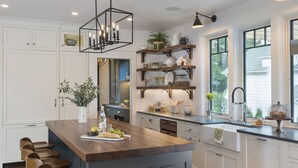 A modern kitchen with a central island, bar stools, and built-in shelves. - The "Idea House" From TV Series This Old House! High End, Definition of Luxury! (Narragansett)
