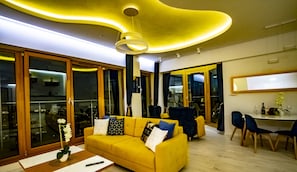 Attico panoramico, 1 camera da letto, vasca da bagno, vista mare | Area soggiorno | Smart TV 50 pollici con canali digitali, TV