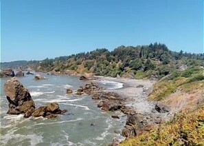 A coastal landscape with rocky shores, clear water, and a forested hillside. - Moonstone Beach Retreat - Beach Lover's Getaway! (Trinidad)