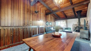 A wooden interior with a dining table, sofas, and a fireplace. - Family Mountain Home, Wood Burning Fireplace. Near The Village Gondola (Mammoth Lakes)