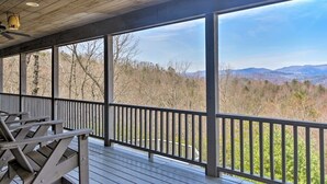 A covered outdoor deck with wooden benches and a view of a forested landscape. - Family and Pet Friendly Mtn Top Cabin, Double Porch, High-Speed WiFi/SmartTVs (Ferguson)