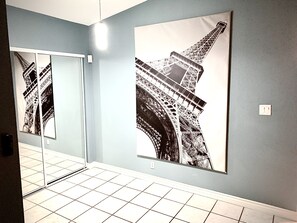 Enjoy the iconic Eiffel Tower view from the comfort of your room, featuring a large mirror and a stylish space.