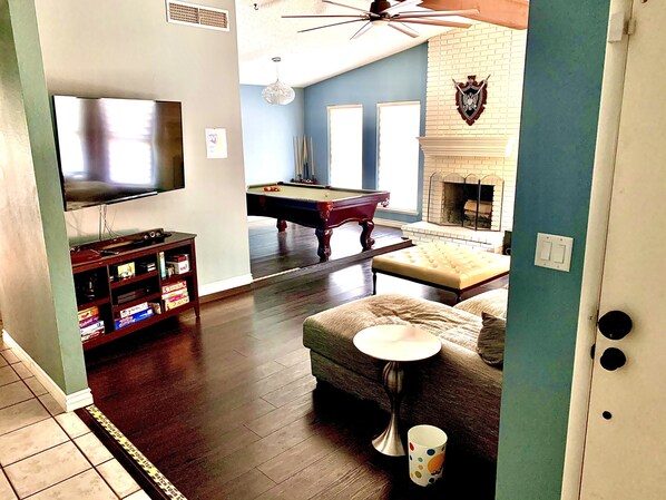 Relax in a cozy living space with a flat-screen TV, pool table, and comfortable seating area.