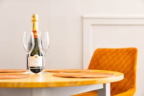 A bottle of Contave Cabernet Sauvignon on a table with two wine glasses.