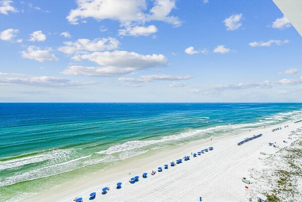 Relax on the beach with comfortable shade under the resort's umbrellas.