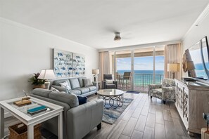 Relax in this stylish living room with a comfortable sofa, flat-screen TV, and ocean views.
