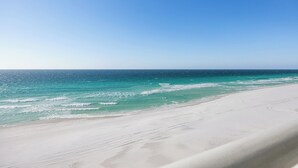 A beach with clear turquoise water and a sandy shore. - Shore Enuff - Destin Gulfgate 0601! (Destin)