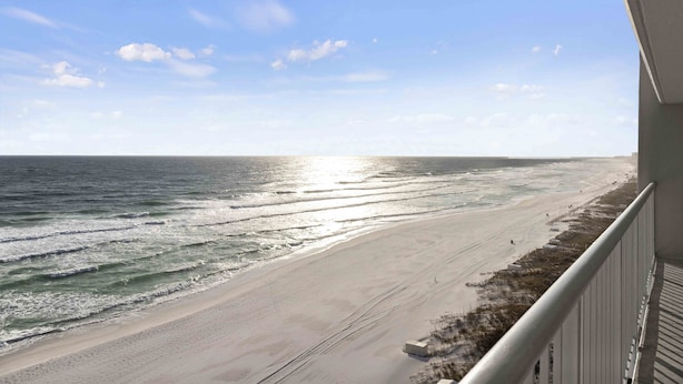 A beach view from a balcony with a railing, ocean waves, and a clear sky. - Beachy Keen - Destin Gulfgate 0805! (Destin)
