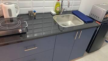 Fridge, microwave, electric kettle, cookware/dishes/utensils