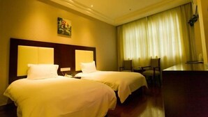 A hotel room with two beds, a desk, and a large window with curtains. - Greentree Inn Qinhuangdao Olympic Center Express (Qinhuangdao)