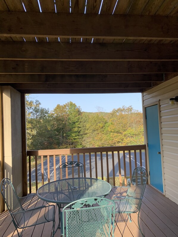 Enjoy an outdoor space with a wooden deck, round table, and comfortable seating for two.
