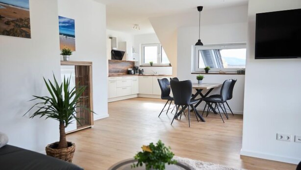 A modern apartment with a dining area, kitchen, and living space. - Landliebe by Interhome (Attendorn)