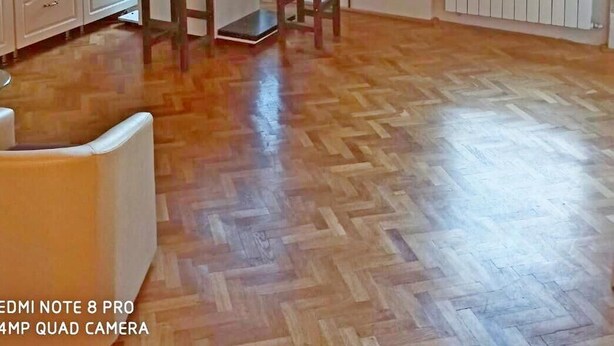 A spacious kitchen with wooden beams, white cabinets, and a herringbone floor pattern. - Style, space and security in ultra central location in Brasov (Brașov)
