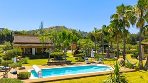 A pool area with lounge chairs, a hot tub, and a view of a hill. - Country House 'Els Oscols 53' with Sea Views, Wi-Fi and Air Conditioning (Alcudia)
