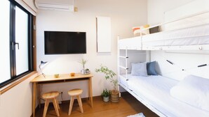 A room with a bunk bed, a desk with two stools, a TV, and a window. - Near Ikebukuro, Kitchen & Laundry, Fast Wi-Fi, 4min to Station,Many restaurants nearby!! (Tokyo)