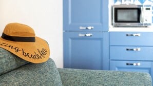 A hat with text, a blue cabinet, and a microwave.