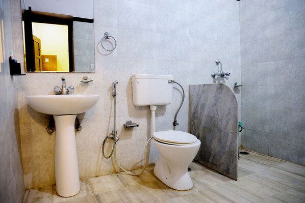 A bathroom with a sink, toilet, and shower.