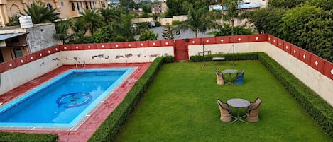 Outdoor pool, open 6:30 AM to 8:00 PM, pool loungers