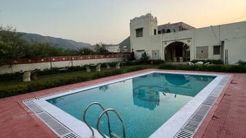 Outdoor pool, open 6:30 AM to 8:00 PM, pool loungers