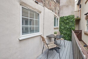 Enjoy a peaceful retreat with a table and chair in this serene outdoor space.