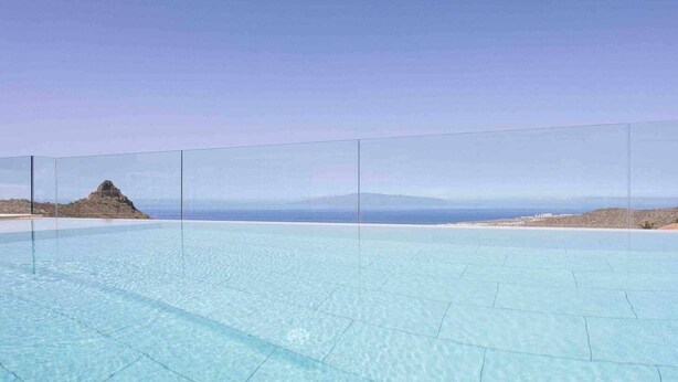 A clear blue infinity pool with a view of the ocean and distant mountains. - "New Home Costa Adeje, Luxurious Private Villa" (Costa Adeje)