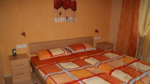 Un dormitorio con una cama grande, dos mesitas de noche y un cuadro en la pared.