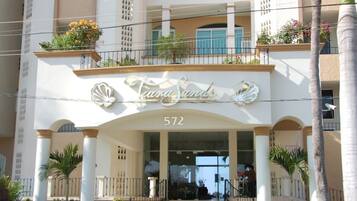 A hotel entrance with a sign reading "Tiara Sands" and the number 572.