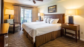 A hotel room with a bed, a desk, a chair, a nightstand, a lamp, a picture on the wall, and a view through the window.