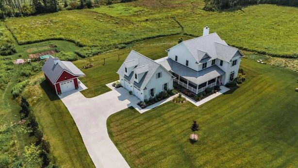 A large, single-story house with a spacious front yard and a separate garage.