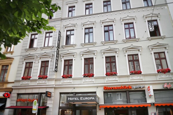 A building with multiple windows, a sign for Hotel Europa, and a Sternbäck restaurant.