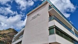 A modern building with a prominent sign reading "GALERIAS FUZ". - Machico Beach, a Home in Madeira (Machico)
