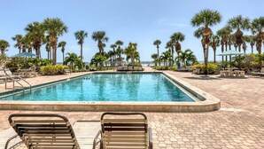 A swimming pool with lounge chairs and palm trees. - Horizons West Villa B-5 - Great Unit on a Great Beach (Sarasota)