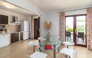 Enjoy meals in the kitchen with an oven and range hood, then dine at the glass-top table with four chairs.
