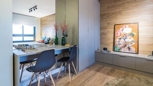 A modern kitchen with a dining area, wooden flooring, and a large window. - Century Park by My Way (Porto Alegre)