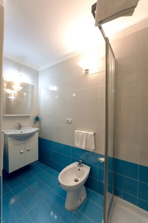 A bathroom with a sink, bidet, and glass shower enclosure. - arbiter toledo - 2 apartments (Napoli)