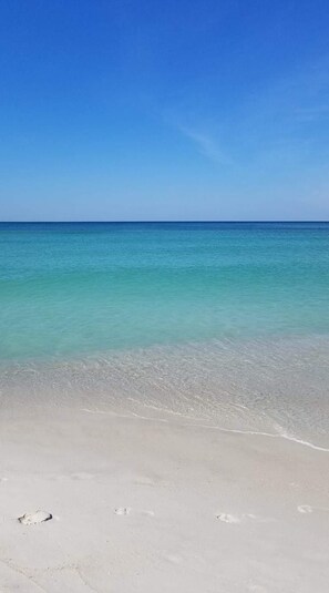 Una playa con agua turquesa cristalina y una orilla de arena.