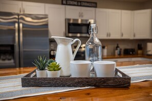 A kitchen counter with a tray holding a pitcher, two cups, and a bottle. - Old Town Scottsdale: Heated Pool, Golf, Nightlife! (Scottsdale)