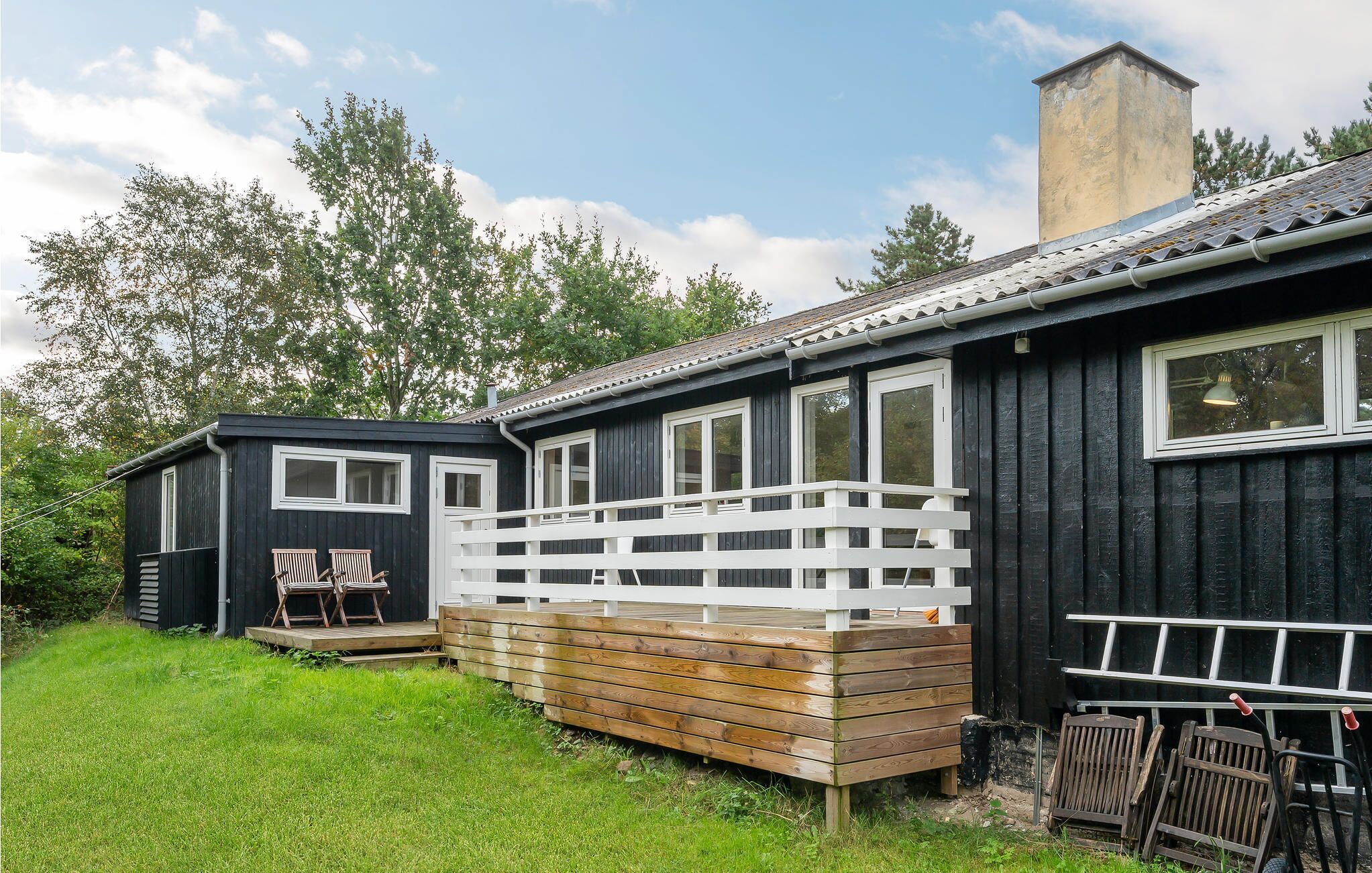 A cabin with a deck and a small porch area.