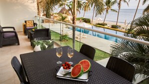 A dining area with a table set for two, featuring a watermelon and wine glasses. - Azul Bucerias 3 Brdm Beachfront,  paradise to enjoy (Bucerías)